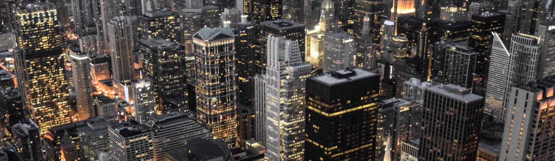 large city buildings illuminated at night